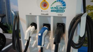 Multi-port EV charging station with different plug types in a commercial lot
